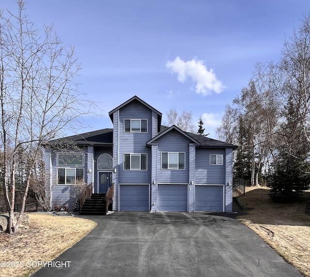 split level home with driveway and a garage