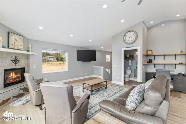 885 Soundview Ave, Homer, AK 99603 - living room featuring light wood finished floors, recessed lighting, a fireplace, baseboards, and lofted ceiling