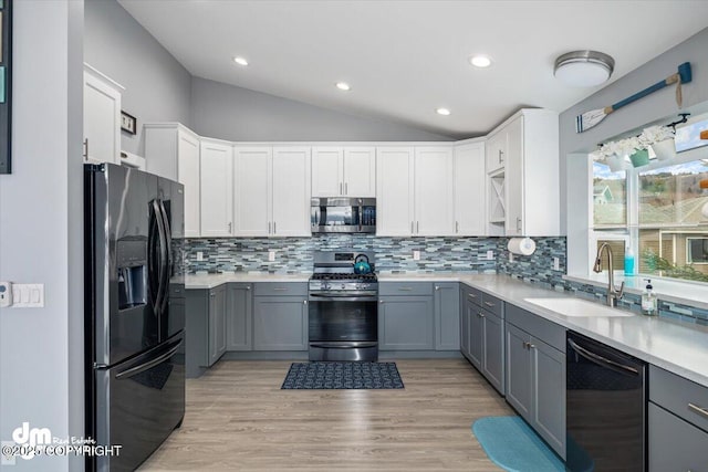 885 Soundview Ave, Homer, AK 99603 - kitchen featuring lofted ceiling, a sink, stainless steel appliances, light countertops, and gray cabinets