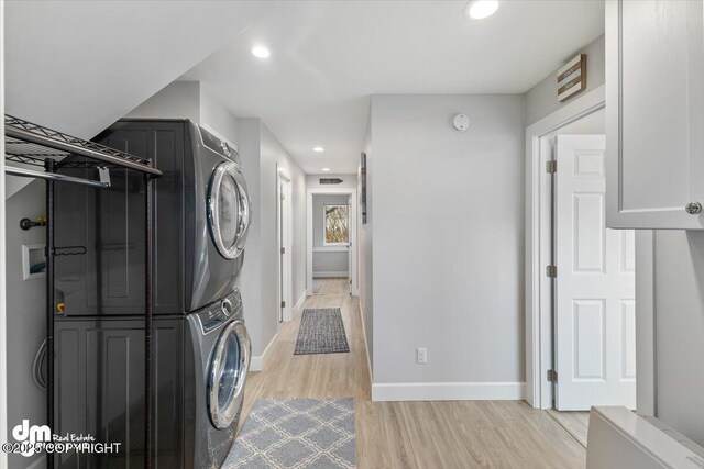 885 Soundview Ave, Homer, AK 99603 - clothes washing area featuring stacked washer / drying machine, light wood-style floors, recessed lighting, and baseboards