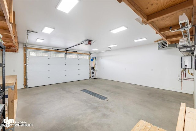 885 Soundview Ave, Homer, AK 99603 - garage featuring a garage door opener and water heater