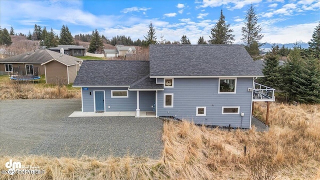 885 Soundview Ave, Homer, AK 99603 - view of front facade featuring a trampoline, a shingled roof, and a patio area