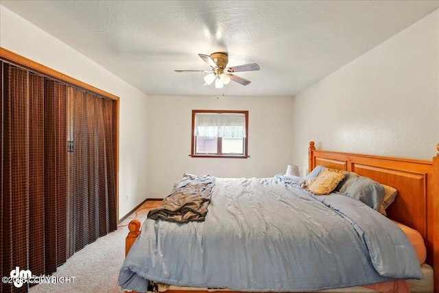 bedroom with carpet floors, a closet, and a ceiling fan