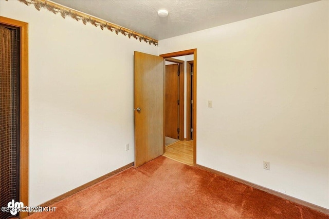 unfurnished bedroom with light carpet and baseboards