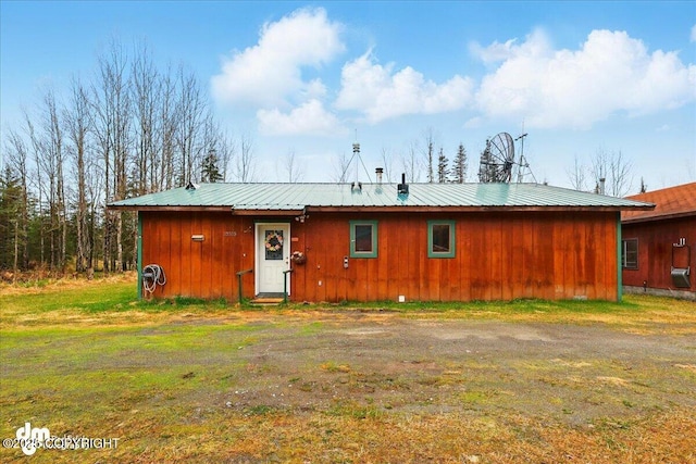 rear view of property featuring metal roof