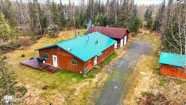 aerial view of property and surrounding area with a forest