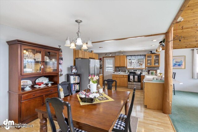 3669 Pullen Cir, Eagle River, AK 99577 - dining room with a chandelier and light wood-style floors