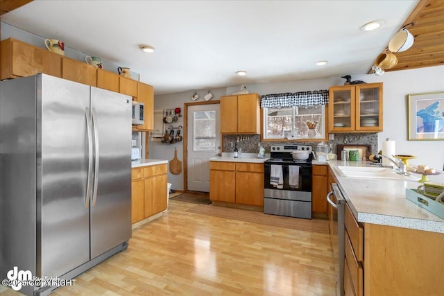 3669 Pullen Cir, Eagle River, AK 99577 - kitchen featuring stainless steel appliances, a sink, light countertops, light wood-style flooring, and recessed lighting