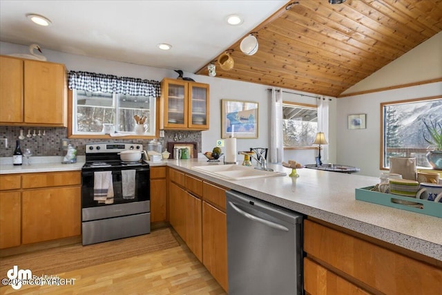 3669 Pullen Cir, Eagle River, AK 99577 - kitchen featuring appliances with stainless steel finishes, a sink, light countertops, tasteful backsplash, and vaulted ceiling
