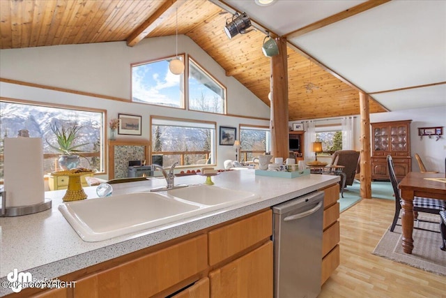 3669 Pullen Cir, Eagle River, AK 99577 - kitchen featuring stainless steel dishwasher, open floor plan, a sink, high vaulted ceiling, and light countertops