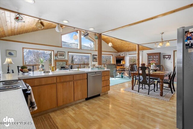 3669 Pullen Cir, Eagle River, AK 99577 - kitchen with stainless steel appliances, a sink, light countertops, light wood-type flooring, and high vaulted ceiling