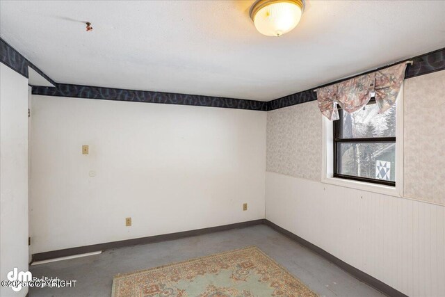 3669 Pullen Cir, Eagle River, AK 99577 - unfurnished room with concrete floors and baseboards