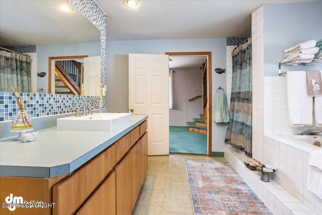 3669 Pullen Cir, Eagle River, AK 99577 - bathroom featuring vanity, a shower with curtain, backsplash, and a bathtub