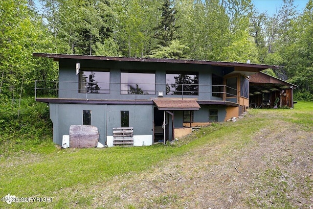 3669 Pullen Cir, Eagle River, AK 99577 - back of house featuring stucco siding and dirt driveway