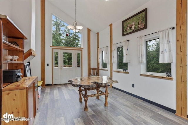 10912 Wolf Trail Cir, Seward, AK 99664 - dining space featuring high vaulted ceiling, wood finished floors, and a chandelier