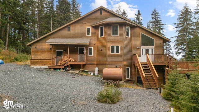10912 Wolf Trail Cir, Seward, AK 99664 - view of front of home with heating fuel, stairs, and a deck