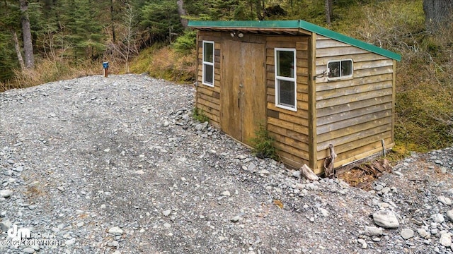 10912 Wolf Trail Cir, Seward, AK 99664 - view of shed with a wooded view