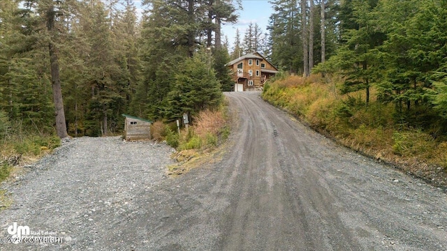 10912 Wolf Trail Cir, Seward, AK 99664 - view of dirt / gravel road with a view of trees