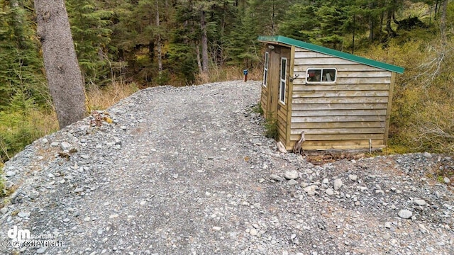 10912 Wolf Trail Cir, Seward, AK 99664 - view of outbuilding featuring a view of trees