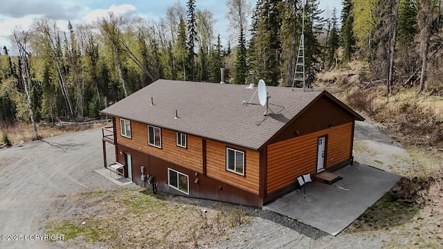 575 Pace St, Soldotna, AK 99669 - rear view of property featuring roof with shingles and a wooded view