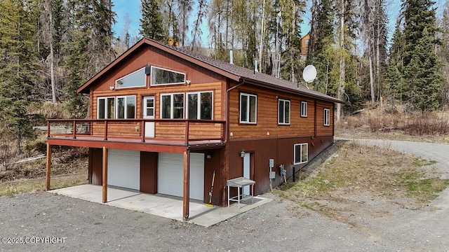 575 Pace St, Soldotna, AK 99669 - back of property featuring a garage and a wooden deck