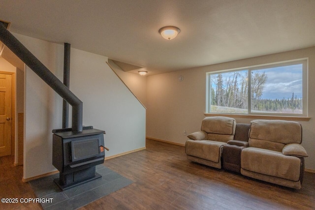 575 Pace St, Soldotna, AK 99669 - living room featuring wood finished floors, baseboards, and a wood stove