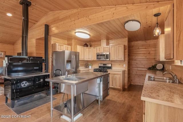 575 Pace St, Soldotna, AK 99669 - kitchen with appliances with stainless steel finishes, wood ceiling, wooden walls, lofted ceiling, and a sink