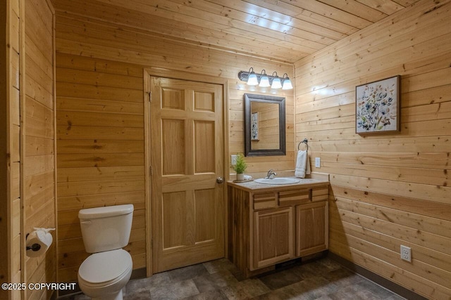 575 Pace St, Soldotna, AK 99669 - bathroom featuring wood walls, toilet, wooden ceiling, and vanity