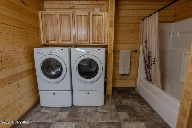 575 Pace St, Soldotna, AK 99669 - clothes washing area with wooden walls, washing machine and clothes dryer, cabinet space, and stone finish floors