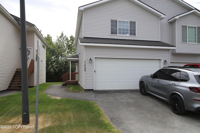 11725 Birch Knoll Loop, Anchorage, AK 99515 - view of front facade featuring driveway, a garage, a front yard, and stairway