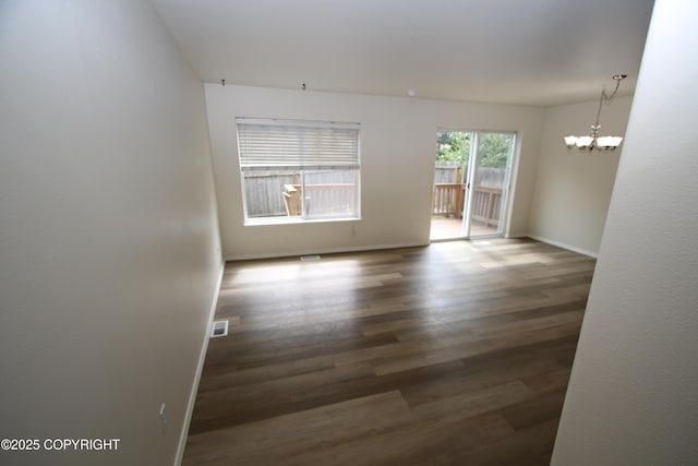 11725 Birch Knoll Loop, Anchorage, AK 99515 - spare room featuring a chandelier and wood finished floors