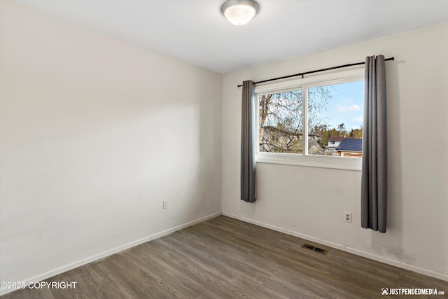 3810 Midvale Cir, Anchorage, AK 99507 - spare room with baseboards, visible vents, and wood finished floors