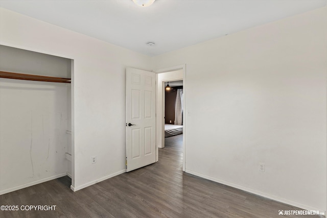 3810 Midvale Cir, Anchorage, AK 99507 - unfurnished bedroom featuring baseboards, a closet, and wood finished floors