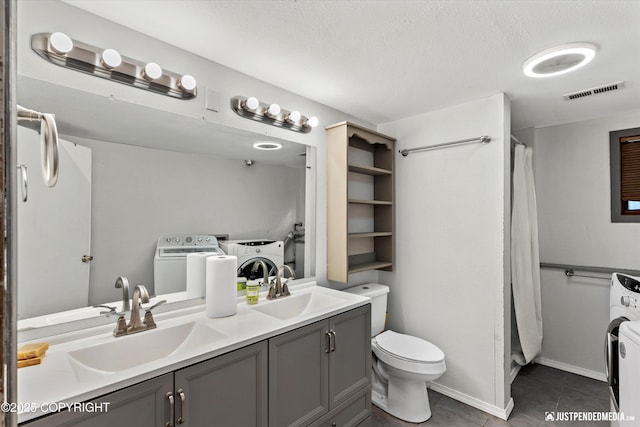 3810 Midvale Cir, Anchorage, AK 99507 - bathroom with tile patterned floors, independent washer and dryer, visible vents, and a sink