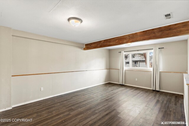 3810 Midvale Cir, Anchorage, AK 99507 - spare room with baseboards, beam ceiling, visible vents, and wood finished floors