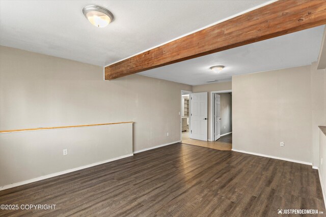 3810 Midvale Cir, Anchorage, AK 99507 - empty room featuring baseboards, beamed ceiling, and wood finished floors