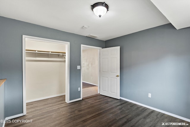 3810 Midvale Cir, Anchorage, AK 99507 - unfurnished bedroom featuring a closet, dark wood-type flooring, baseboards, and visible vents