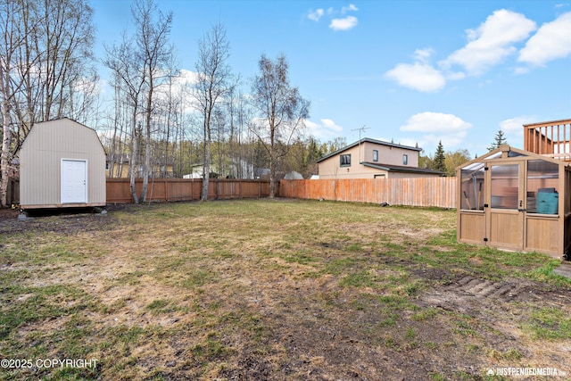 3810 Midvale Cir, Anchorage, AK 99507 - view of yard with a greenhouse, an outdoor structure, and a fenced backyard