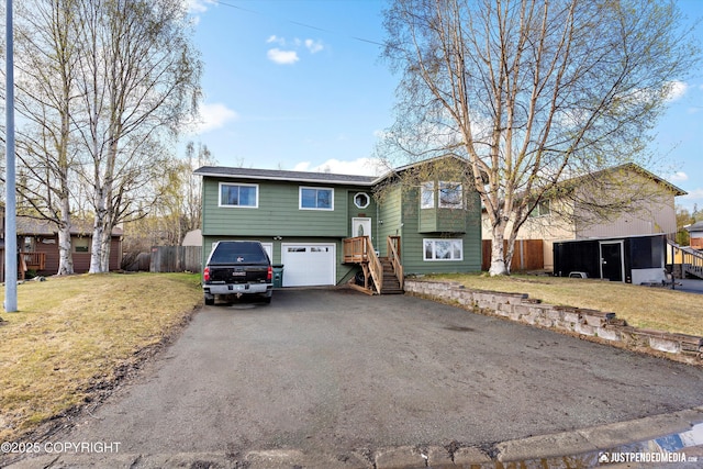 3810 Midvale Cir, Anchorage, AK 99507 - bi-level home with fence, an attached garage, a front lawn, and driveway