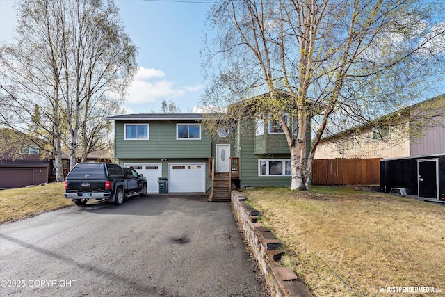 3810 Midvale Cir, Anchorage, AK 99507 - raised ranch featuring aphalt driveway, fence, an attached garage, and a front lawn