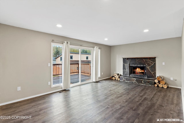 3810 Midvale Cir, Anchorage, AK 99507 - unfurnished living room featuring a stone fireplace, dark wood-type flooring, and recessed lighting