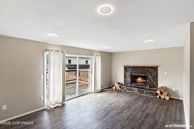 3810 Midvale Cir, Anchorage, AK 99507 - unfurnished living room with wood finished floors, baseboards, and a stone fireplace