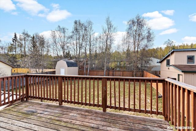 3810 Midvale Cir, Anchorage, AK 99507 - deck with a fenced backyard, a storage shed, a yard, and an outdoor structure