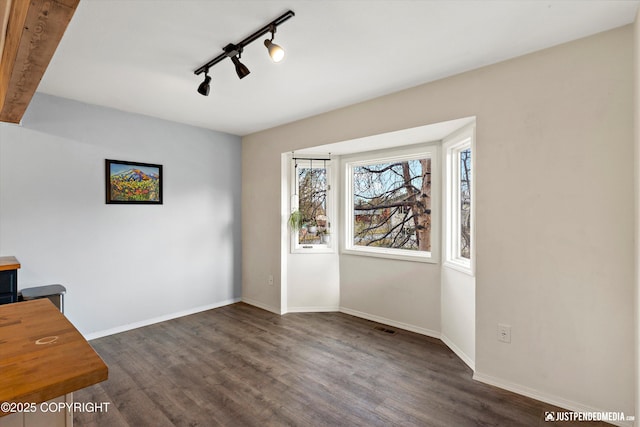 3810 Midvale Cir, Anchorage, AK 99507 - unfurnished office with track lighting, visible vents, baseboards, and dark wood-style floors