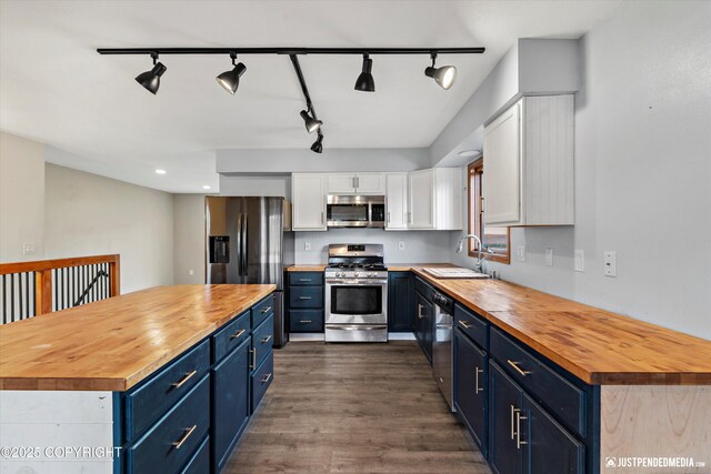 3810 Midvale Cir, Anchorage, AK 99507 - kitchen featuring wooden counters, appliances with stainless steel finishes, and blue cabinetry