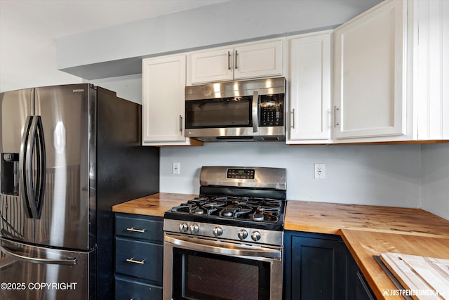 3810 Midvale Cir, Anchorage, AK 99507 - kitchen with blue cabinets, stainless steel appliances, wooden counters, and white cabinets