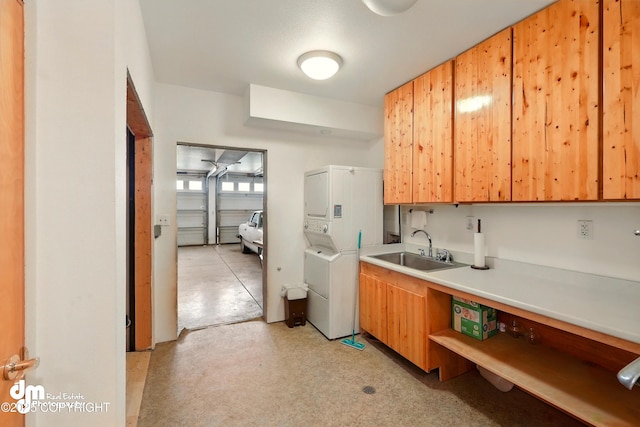 29425 Fools Gold St, Soldotna, AK 99669 - kitchen featuring stacked washer and clothes dryer, a sink, and light countertops