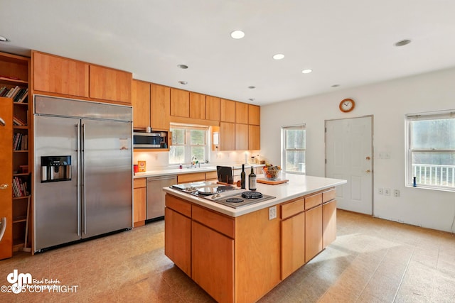 29425 Fools Gold St, Soldotna, AK 99669 - kitchen featuring stainless steel appliances, a center island, light countertops, a sink, and recessed lighting