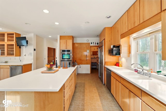 29425 Fools Gold St, Soldotna, AK 99669 - kitchen with a sink, appliances with stainless steel finishes, a kitchen island, light countertops, and recessed lighting