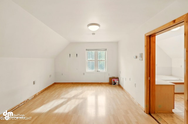 29425 Fools Gold St, Soldotna, AK 99669 - additional living space featuring vaulted ceiling, light wood-style floors, and baseboards